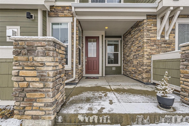 doorway to property with stone siding