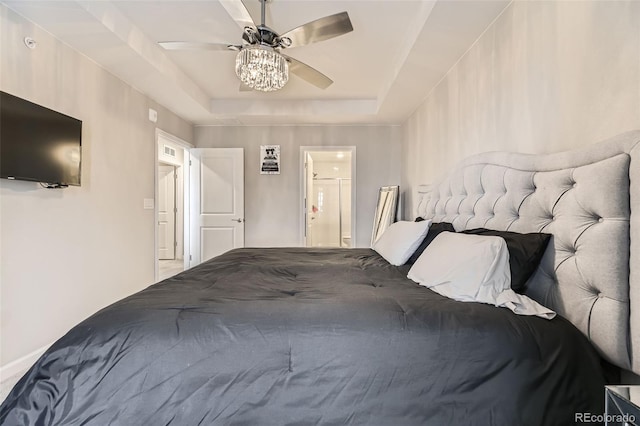 bedroom featuring a raised ceiling and ceiling fan