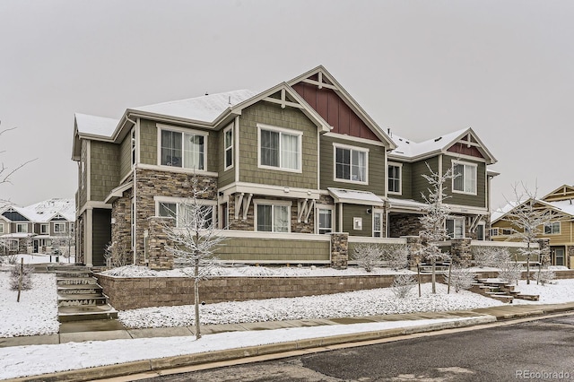 view of front of property featuring stone siding and board and batten siding