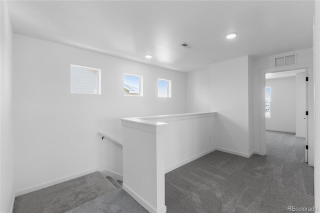 hall featuring carpet floors, an upstairs landing, baseboards, plenty of natural light, and recessed lighting