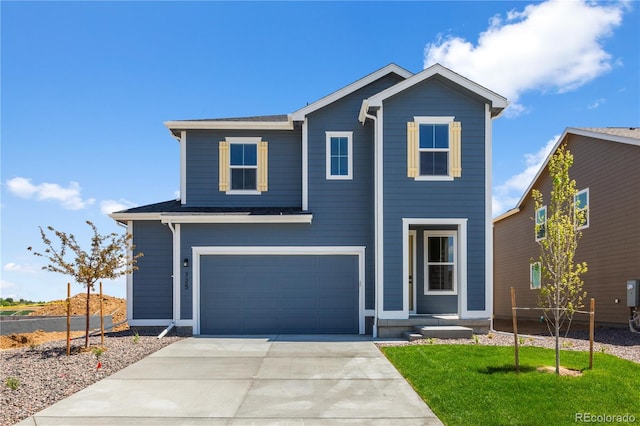 view of front facade with a garage, concrete driveway, and a front yard