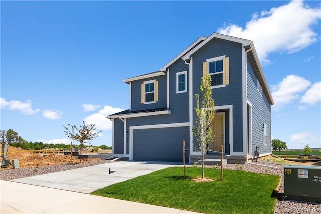 view of front of home featuring a garage, driveway, and a front lawn