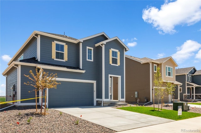 traditional-style home with an attached garage and concrete driveway