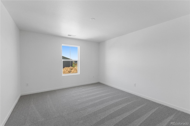 carpeted empty room with baseboards