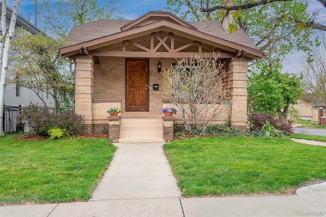 401 S Williams St, Denver, CO 80209 - view of front of property featuring a front yard, roof with shingles, and brick siding