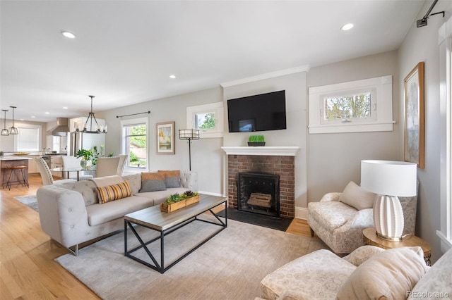 401 S Williams St, Denver, CO 80209 - living room with light wood-style floors, a fireplace, recessed lighting, and baseboards