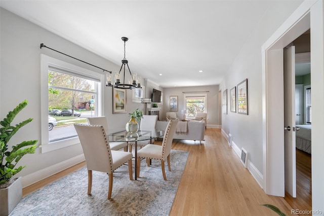 401 S Williams St, Denver, CO 80209 - dining room with a chandelier, plenty of natural light, light wood-style floors, baseboards, and recessed lighting