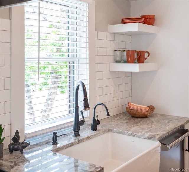 401 S Williams St, Denver, CO 80209 - kitchen with a sink, tasteful backsplash, stainless steel dishwasher, open shelves, and light stone countertops