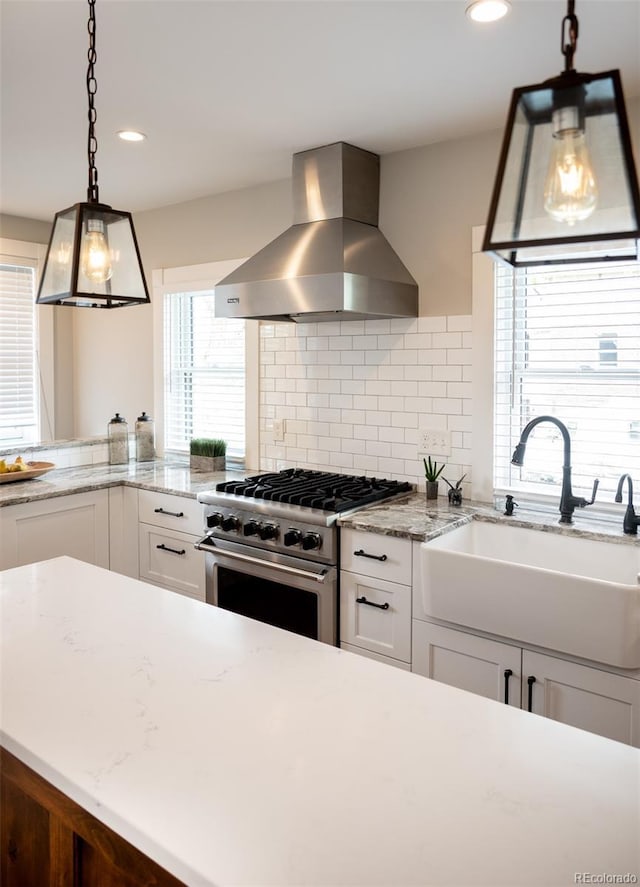 401 S Williams St, Denver, CO 80209 - kitchen featuring ventilation hood, high end stainless steel range, a sink, white cabinets, and recessed lighting