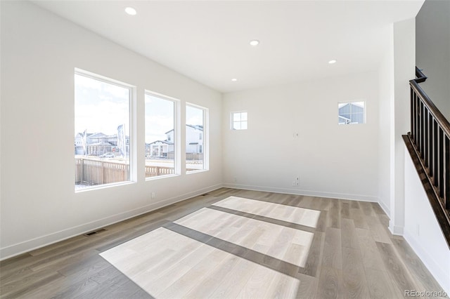 unfurnished room with light wood-type flooring