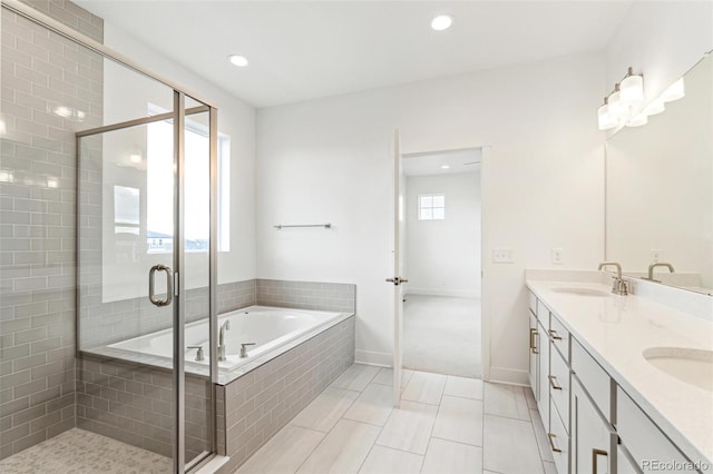 bathroom with tile patterned flooring, vanity, and independent shower and bath