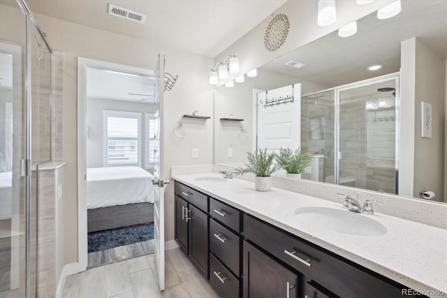 2395 S Troy Ct, Aurora, CO 80014 - ensuite bathroom featuring double vanity and a shower stall