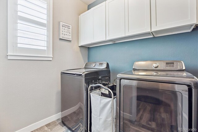 2395 S Troy Ct, Aurora, CO 80014 - laundry room with washing machine and clothes dryer and cabinet space