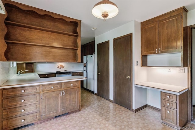 9 Rangeview Dr, Wheat Ridge, CO 80215 - kitchen with open shelves, fridge with ice dispenser, and light floors