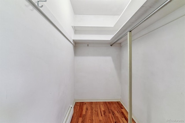9 Rangeview Dr, Wheat Ridge, CO 80215 - spacious closet featuring wood finished floors and a baseboard radiator