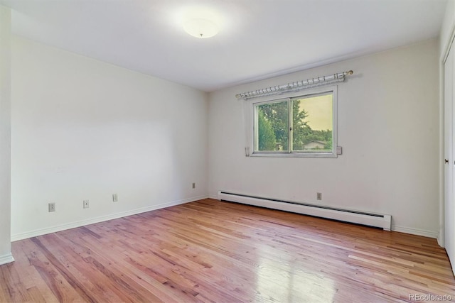9 Rangeview Dr, Wheat Ridge, CO 80215 - empty room featuring a baseboard heating unit and light wood-style flooring