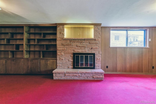 9 Rangeview Dr, Wheat Ridge, CO 80215 - unfurnished living room featuring carpet, a brick fireplace, and wood walls
