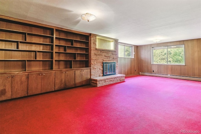 9 Rangeview Dr, Wheat Ridge, CO 80215 - unfurnished living room featuring a fireplace, carpet floors, a baseboard heating unit, and wood walls