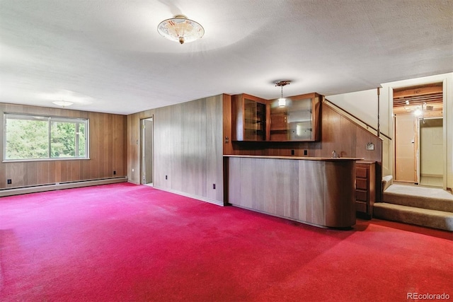 9 Rangeview Dr, Wheat Ridge, CO 80215 - kitchen featuring a baseboard heating unit, carpet floors, wooden walls, and glass insert cabinets