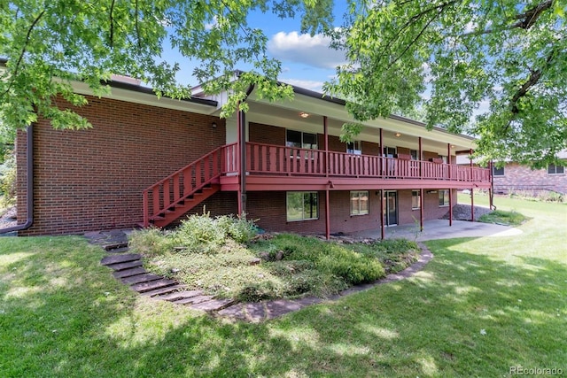 9 Rangeview Dr, Wheat Ridge, CO 80215 - rear view of property with brick siding, a lawn, a patio, and a deck