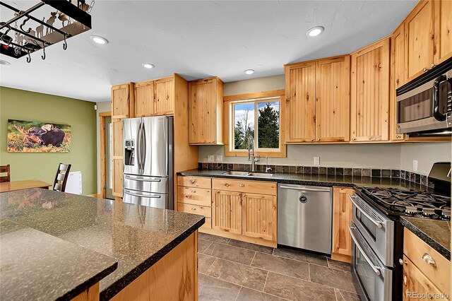 10436 Jeanette Ct, Morrison, CO 80465 - kitchen featuring appliances with stainless steel finishes, recessed lighting, dark stone finish flooring, and light brown cabinetry