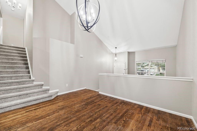 5796 E 129th Pl, Thornton, CO 80602 - staircase with wood finished floors, a chandelier, and high vaulted ceiling