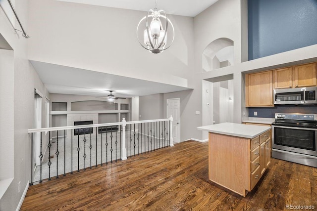 5796 E 129th Pl, Thornton, CO 80602 - kitchen featuring stainless steel appliances, dark wood-style floors, ceiling fan, a high ceiling, and a chandelier