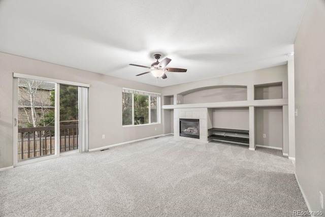 5796 E 129th Pl, Thornton, CO 80602 - unfurnished living room featuring carpet flooring, ceiling fan, and a tile fireplace