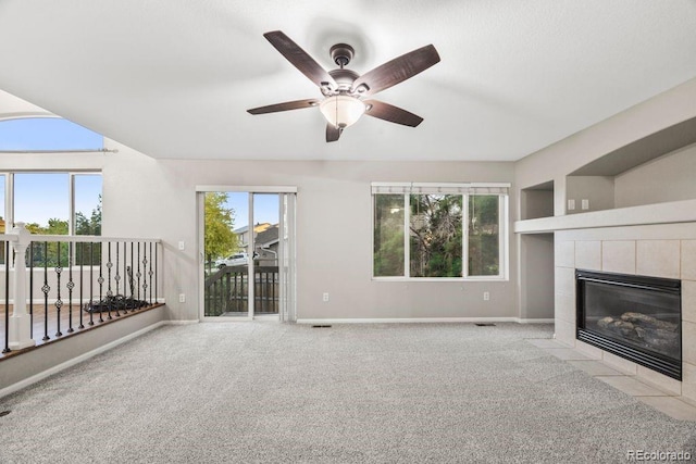 5796 E 129th Pl, Thornton, CO 80602 - unfurnished living room with a tile fireplace, carpet flooring, and ceiling fan