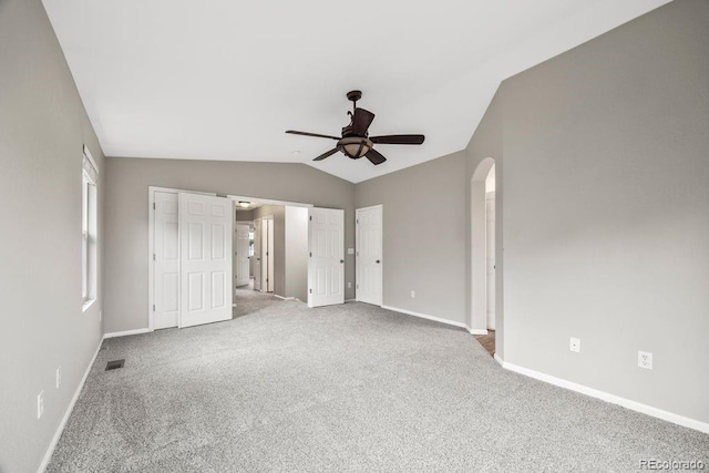 5796 E 129th Pl, Thornton, CO 80602 - unfurnished bedroom featuring vaulted ceiling, carpet flooring, arched walkways, ceiling fan, and multiple closets