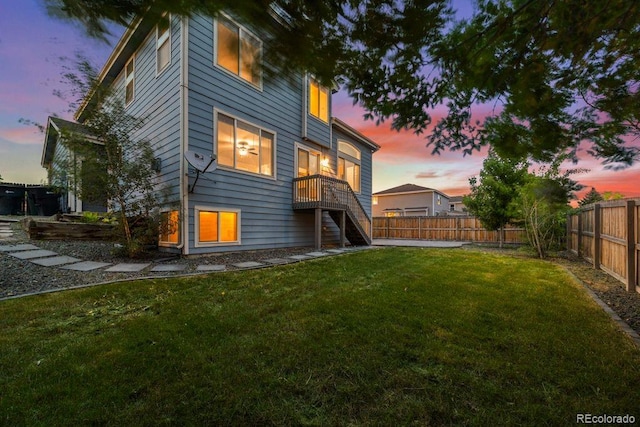 5796 E 129th Pl, Thornton, CO 80602 - back of house at dusk with stairs and a fenced backyard