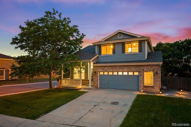5796 E 129th Pl, Thornton, CO 80602 - view of front facade with concrete driveway, brick siding, a garage, and covered porch