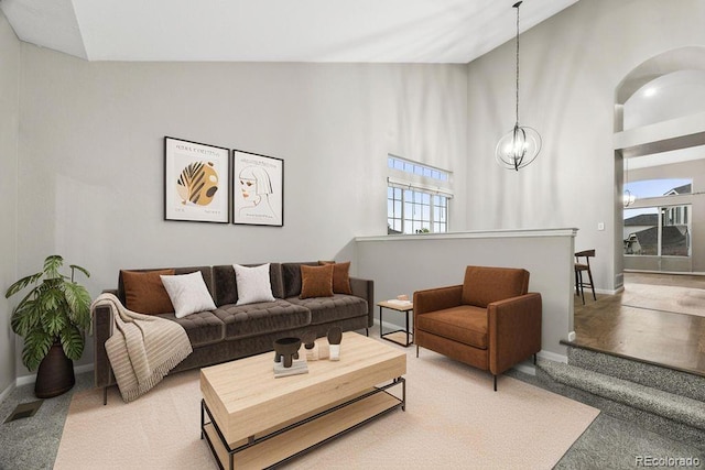 5796 E 129th Pl, Thornton, CO 80602 - carpeted living room with a chandelier and vaulted ceiling