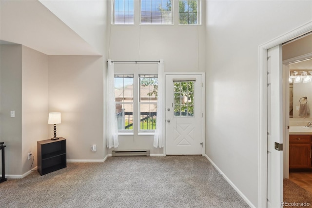 1601 W Swallow Rd Unit 9, Fort Collins, CO 80526 - carpeted foyer entrance with a baseboard heating unit, a towering ceiling, and baseboards