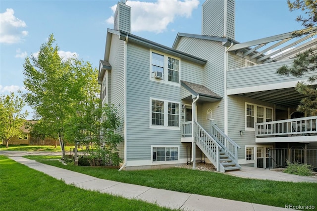 1601 W Swallow Rd Unit 9, Fort Collins, CO 80526 - back of house featuring a chimney and a yard