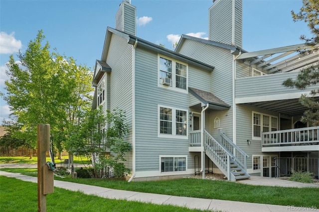 1601 W Swallow Rd Unit 9, Fort Collins, CO 80526 - rear view of property with a chimney and a yard