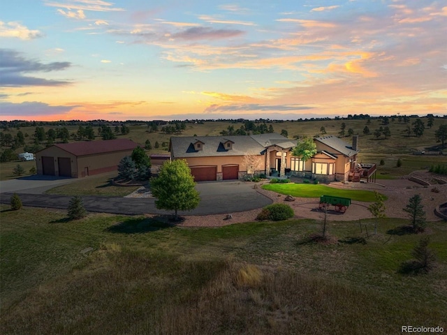 11624 Dunrich Rd, Parker, CO 80138 - view of front of home with curved driveway, stucco siding, and a garage