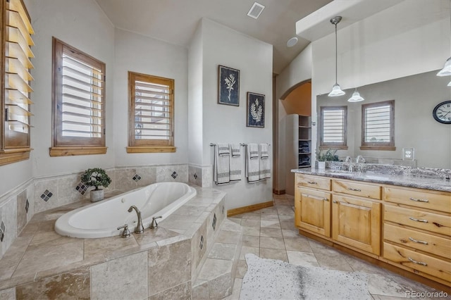11624 Dunrich Rd, Parker, CO 80138 - bathroom with vanity, a garden tub, and healthy amount of natural light