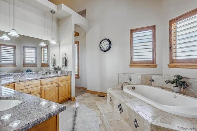 11624 Dunrich Rd, Parker, CO 80138 - bathroom with double vanity and a bath