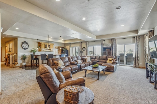 11624 Dunrich Rd, Parker, CO 80138 - living room featuring a tray ceiling, light colored carpet, healthy amount of natural light, and recessed lighting