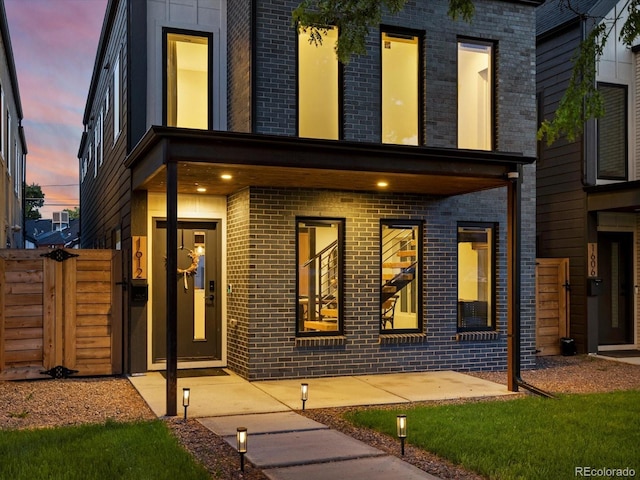 1612 Wolff St, Denver, CO 80204 - view of front of home with brick siding and a gate