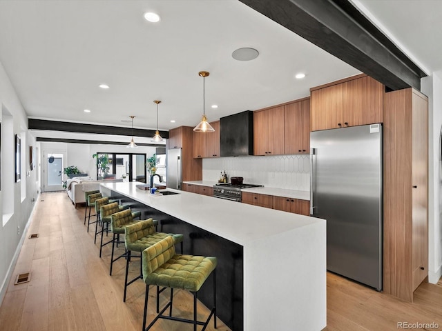 1612 Wolff St, Denver, CO 80204 - kitchen with high quality appliances, range hood, light countertops, recessed lighting, and decorative backsplash