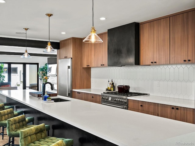 1612 Wolff St, Denver, CO 80204 - kitchen featuring high end appliances, exhaust hood, light countertops, a kitchen breakfast bar, and recessed lighting