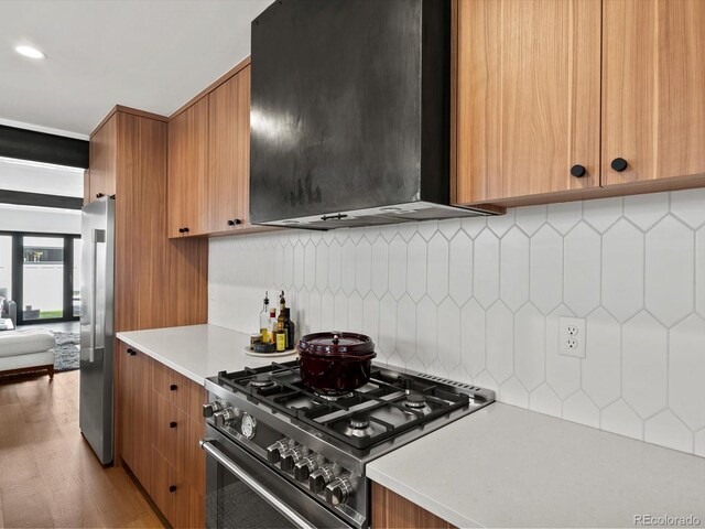 1612 Wolff St, Denver, CO 80204 - kitchen with stainless steel appliances, extractor fan, light countertops, and brown cabinets