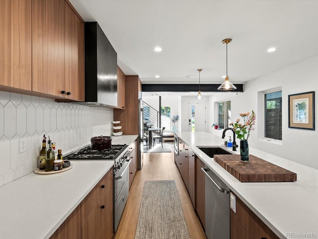1612 Wolff St, Denver, CO 80204 - kitchen with appliances with stainless steel finishes, light wood-style flooring, light countertops, decorative backsplash, and pendant lighting