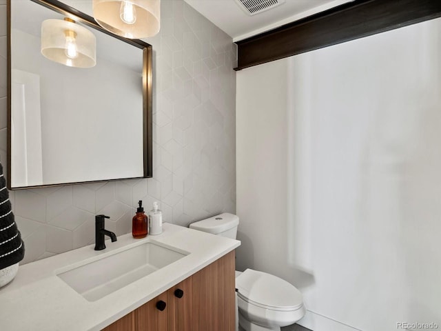 1612 Wolff St, Denver, CO 80204 - bathroom featuring vanity, tasteful backsplash, and tile walls