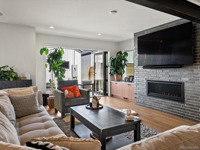 1612 Wolff St, Denver, CO 80204 - living area featuring light wood-style flooring, recessed lighting, and a fireplace