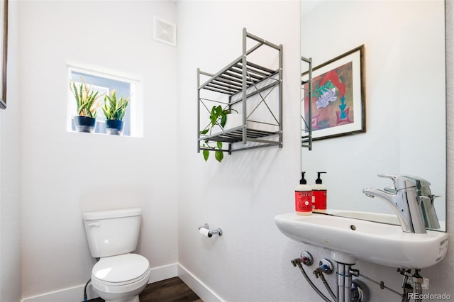 5630 W 11th Pl, Lakewood, CO 80214 - bathroom with toilet, baseboards, wood finished floors, and a sink