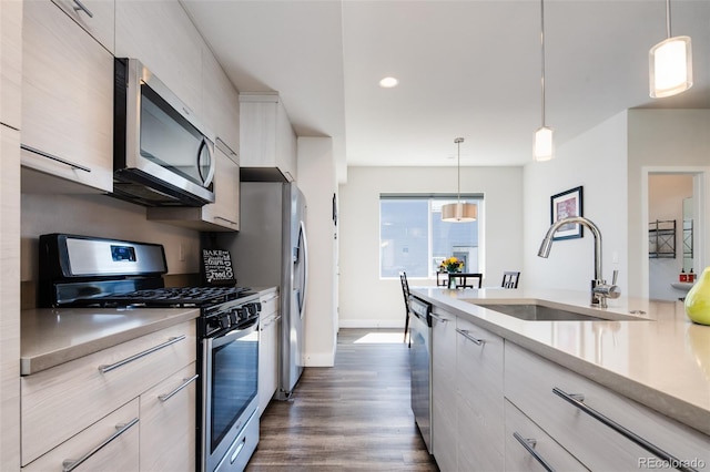 5630 W 11th Pl, Lakewood, CO 80214 - kitchen featuring stainless steel appliances, light countertops, a sink, modern cabinets, and recessed lighting