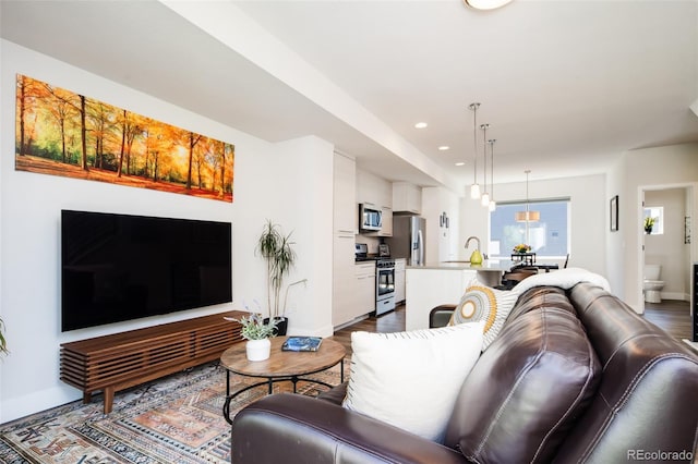 5630 W 11th Pl, Lakewood, CO 80214 - living area with dark wood-style floors, baseboards, and recessed lighting